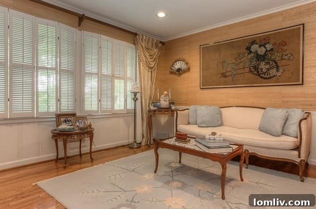 Formal living room with grass cloth walls at 208 Rockwood Drive, offering a blank canvas for modern design updates.