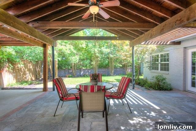 Expansive backyard with covered patio and mature trees at 10542 Wyatt Street