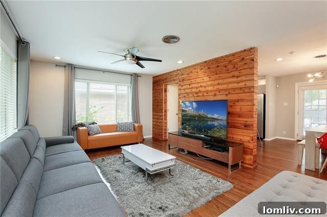 Two Lochwood Homes: A Splurge and a Steal, Both with New Lower Prices 9 Bright living room with wood accent wall at 11635 Cimarec Street