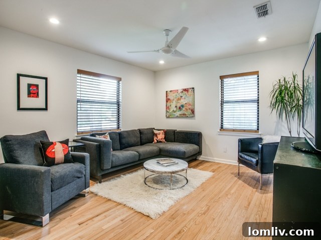 Open concept living area with stylish wood accent wall in Dallas home