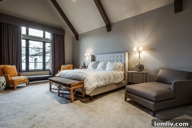 Elegant master bedroom with vaulted and beamed ceiling