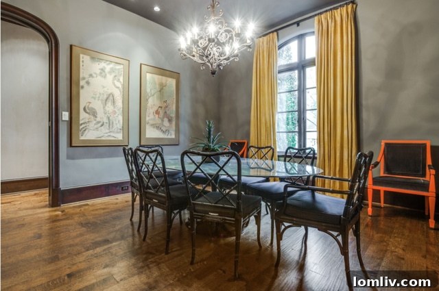 Elegant formal dining room with arched doorway and oversized windows