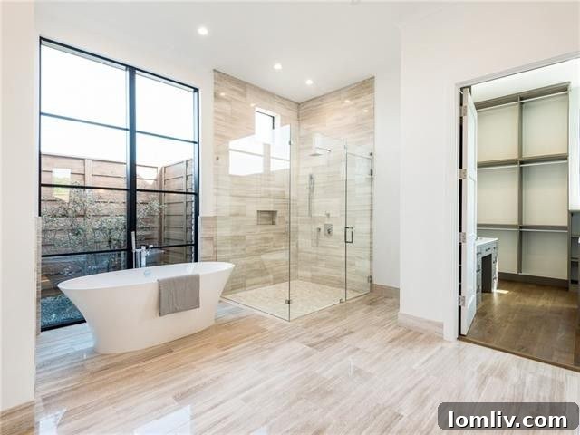 Luxurious Master Bathroom with Dual Vanities and Elegant Finishes