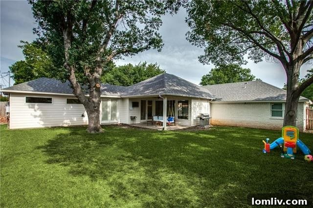 Inviting backyard with covered patio and green space