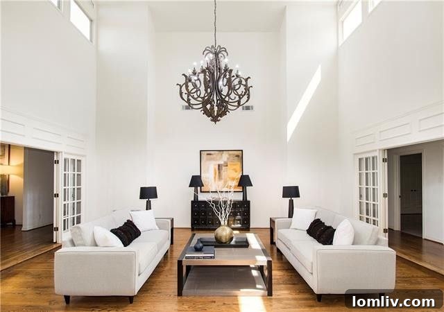 Bright and airy two-story atrium living room with vaulted ceiling and exposed rafter beams