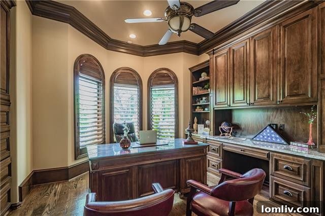 A refined formal office offers custom built-in cabinets and an exceptionally large closet, with tall windows featuring plantation shutters providing a view to the front of the house.