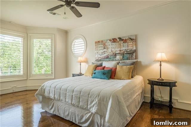 One of four exquisite upstairs guest suites, complete with a functional built-in desk, a spacious walk-in closet, and elegant plantation shutters, offering comfort and style.