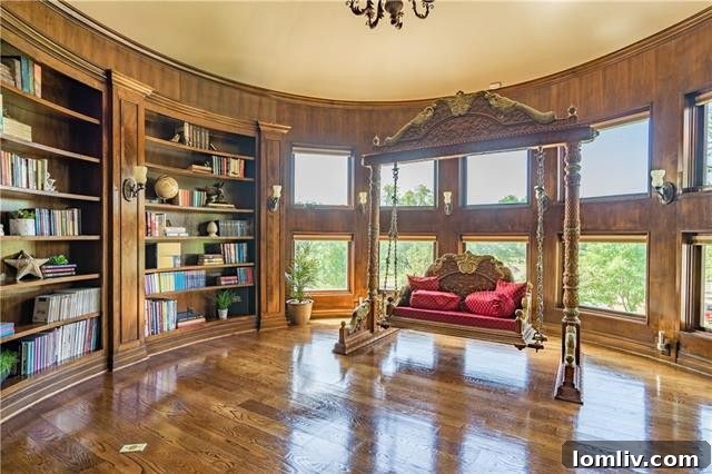 The circular library located upstairs offers a tranquil and elegant space for reading, conveniently situated just off the entrance to the home's private elevator.