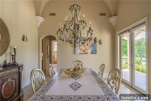 The sophisticated formal dining room features double-sided glass doors that open gracefully to a front patio, perfect for elegant gatherings and al fresco dining.