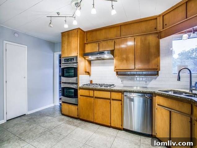 Modern Kitchen with Original Wood Cabinetry, Stainless Steel Appliances, and Granite Countertops