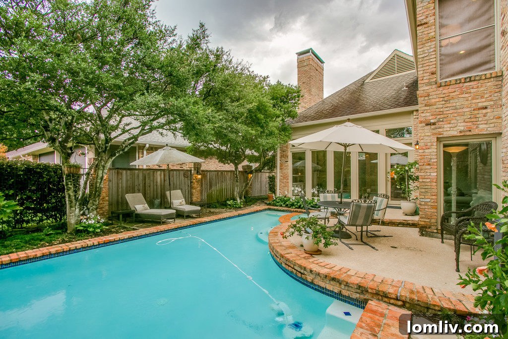 The inviting pool and spa area with a newly installed cool pool surface, ideal for Dallas summers