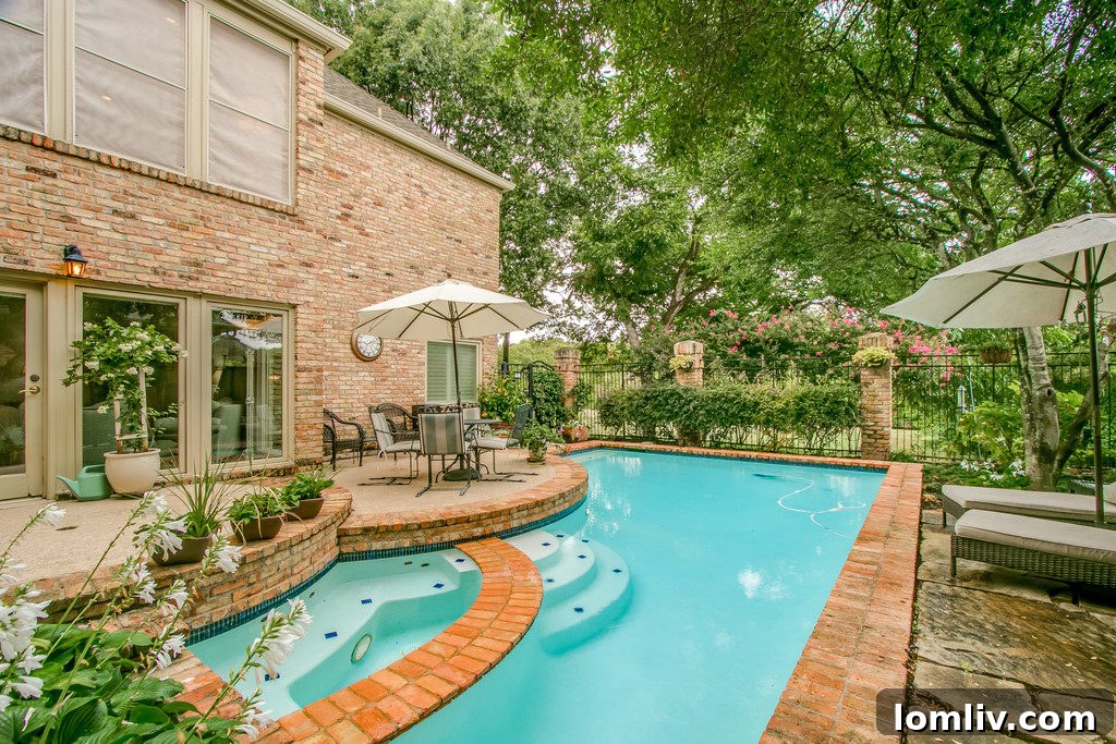 Aerial view of the stunning backyard, pool, and direct access to the greenbelt
