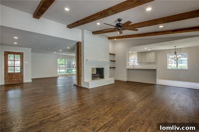 Inviting entryway and open living space showcasing exposed brick and natural light