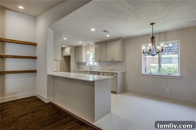 Detailed view of the living room showcasing hardwood floors and exposed brick wall