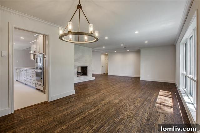 Modern kitchen with warm gray cabinetry, stainless steel appliances, and breakfast bar