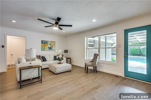 Open concept living area with new hardwood floors and recessed lighting