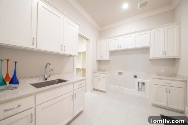 Another view of the elegant kitchen island and bar seating