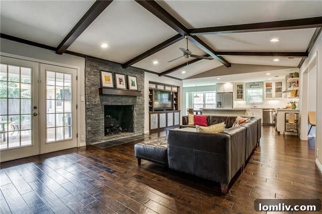 Living Room with Beamed Ceiling and Stone Fireplace