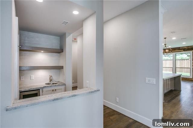 Stylish wet bar with wine refrigerator, perfect for entertaining.