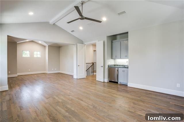 Spacious upstairs flex space with wet bar and hardwood floors, perfect for versatile use.