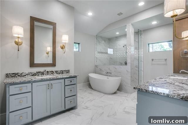 Luxury master bathroom with dual vanities, granite, and designer tiles.