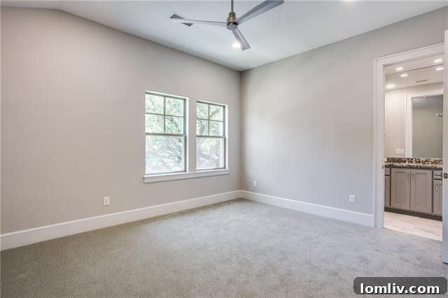 Well-appointed secondary bedroom on the upper floor of a custom home.