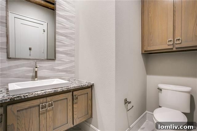 Elegant secondary bathroom with custom tiling and premium finishes.