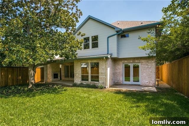 Private backyard with mature tree, covered and open patios, ideal for family enjoyment.