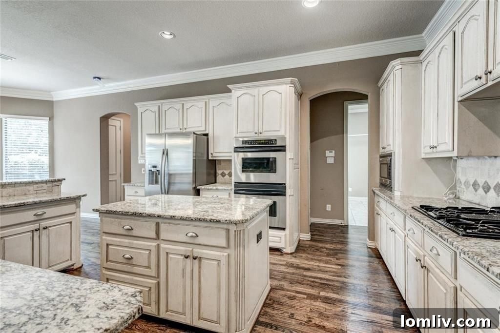 Kitchen with stainless steel appliances, 5-burner cooktop, double oven, and granite countertops