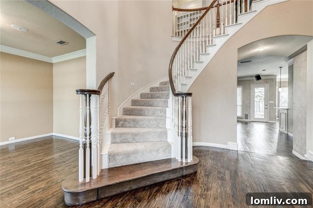 Foyer with stairs, dining room to left, and living room to right
