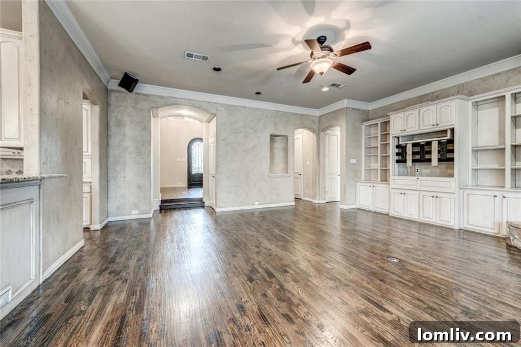 Open concept living room flowing into kitchen area