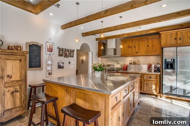 Modern kitchen with stainless steel countertops and custom cabinetry.