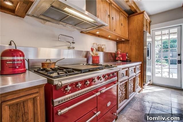 A vibrant red Lacanche gas stove in a luxury kitchen.