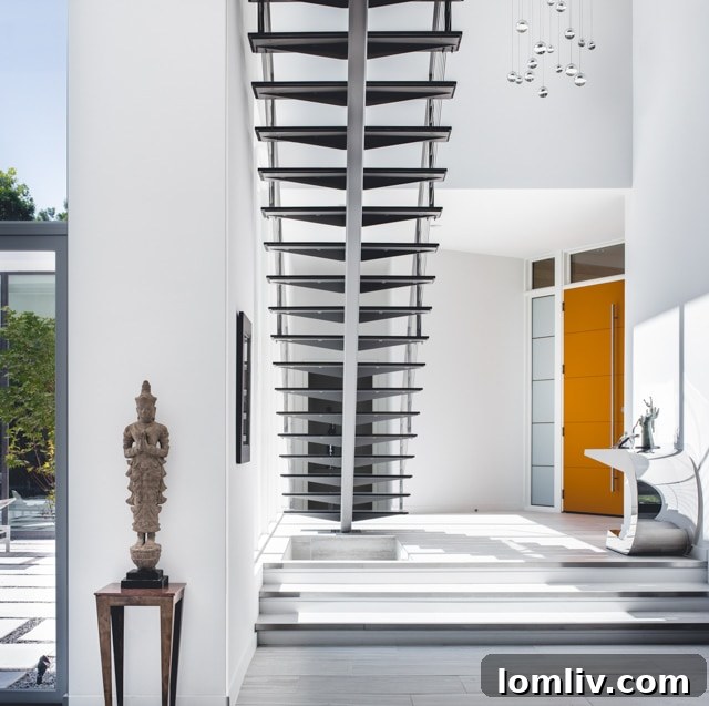 Elegant dining room with modern chandelier, wooden table, and large windows overlooking a scenic view.