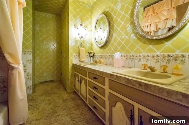 A bathroom with distinctive 1970s features, including patterned wallpaper, vintage fixtures, and a classic tiled shower.