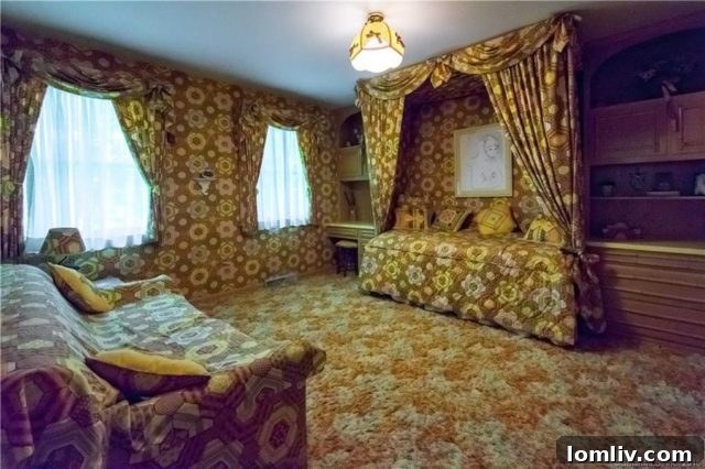 A 1970s themed bedroom where the bed's headboard and comforter perfectly match the distinctive floral wallpaper, creating a unified and immersive vintage look.
