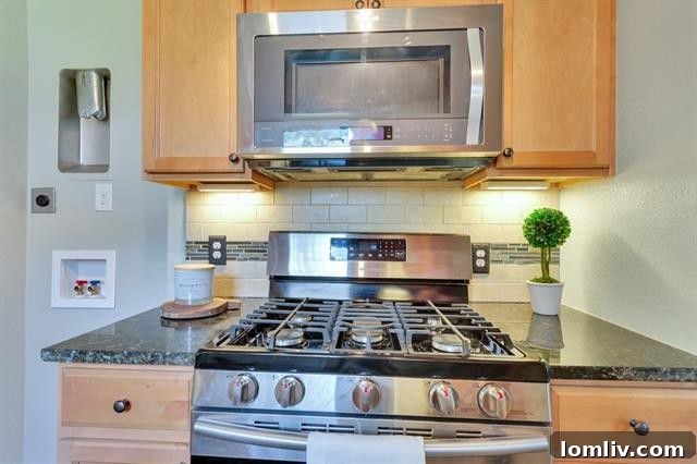 Modern kitchen featuring a deep farmhouse sink, sleek granite counters, and stainless steel appliances