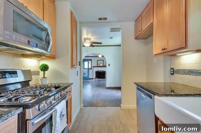 Detailed view of the kitchen with ample 42-inch cabinets and beautifully tiled wood-look floors