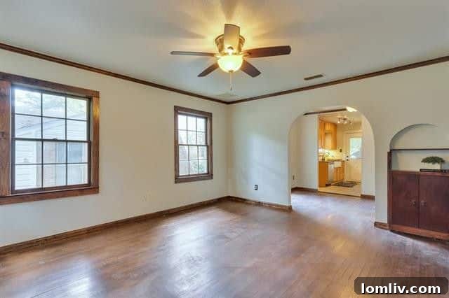 Spacious living room featuring original hardwood floors and an abundance of natural light