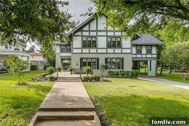 Charming gray Tudor-style home on Elizabeth Boulevard with manicured landscaping