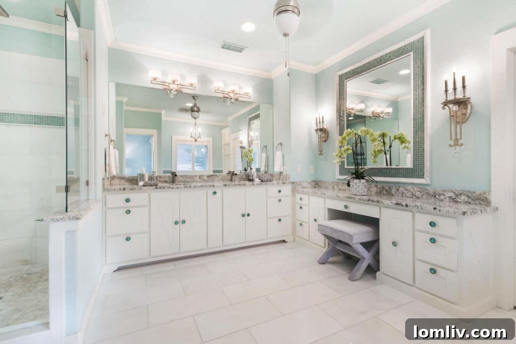 Luxurious marble master bathroom with double vanity and custom cabinets