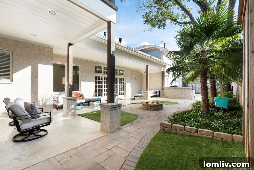 Low-maintenance backyard with artificial turf, fire pit, and water feature