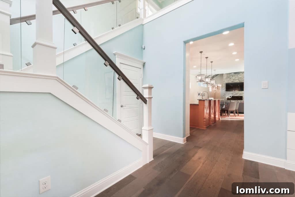 Bright and airy entryway with frameless glass and modern stair railing
