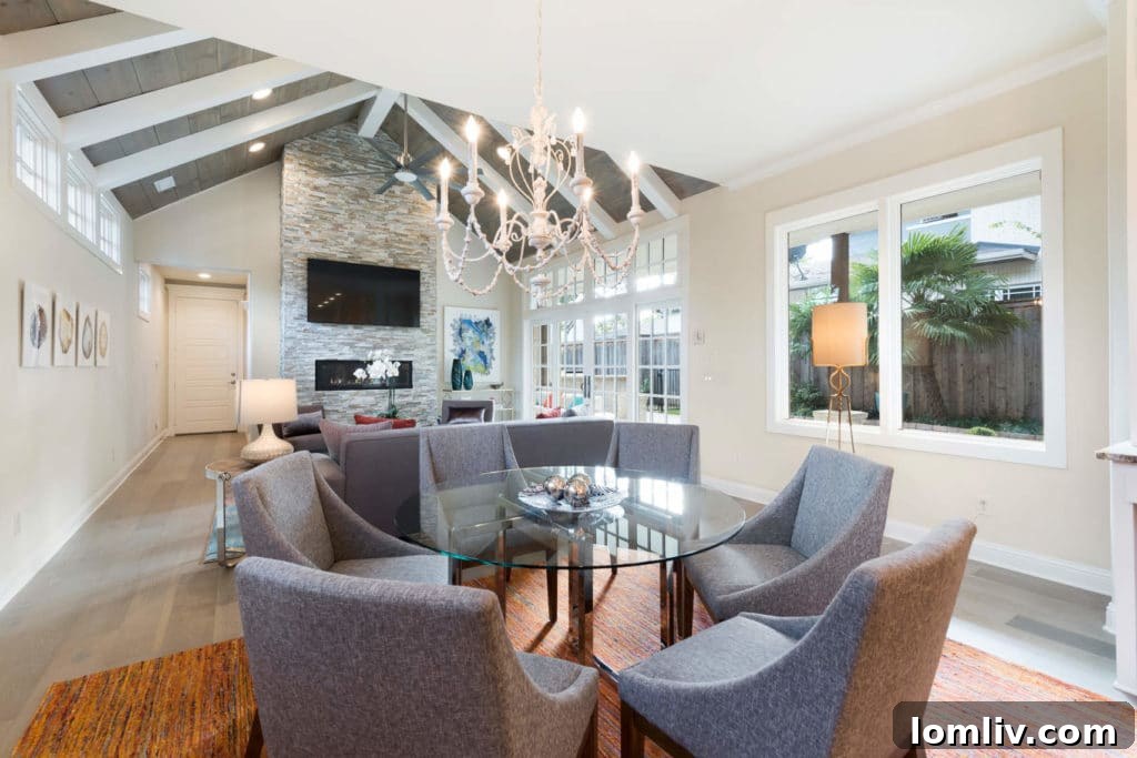 Modern dining area open to the kitchen with unique chandelier