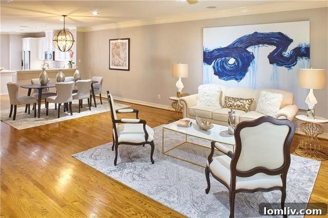 Dining area adjacent to the kitchen, featuring contemporary lighting and hardwood floors