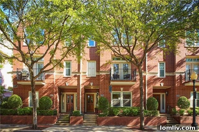 Charming brownstone exterior on State Street in Uptown Dallas, surrounded by lush greenery