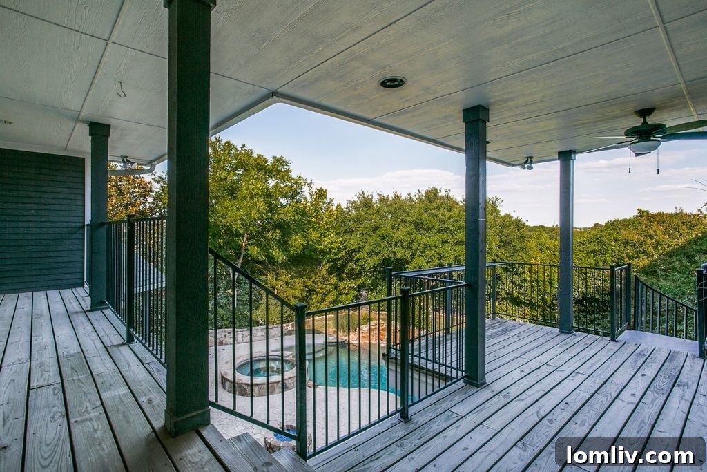 Expansive outdoor patio with built-in grill and fireplace for entertainment