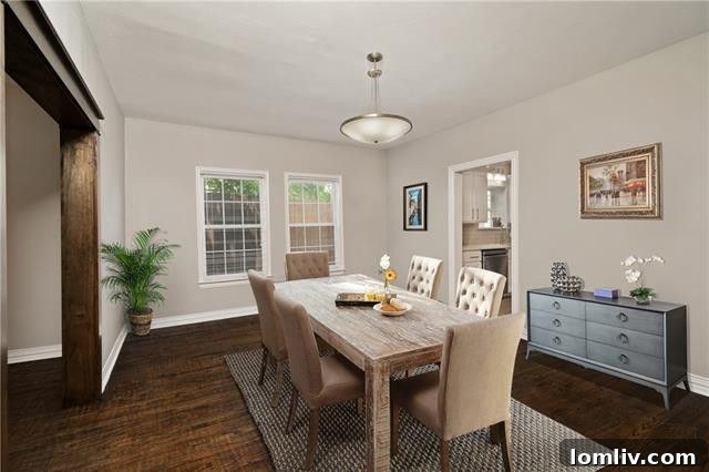 A cozy bedroom with a large window, highlighting the comfortable living spaces of this Oak Cliff home.