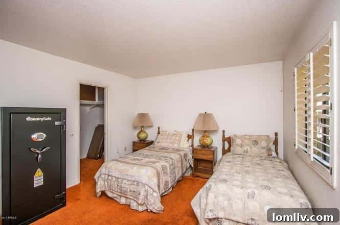70s Reflection Rocks the Panel 15 Bedroom with orange carpet, mismatched bedding, and a large safe