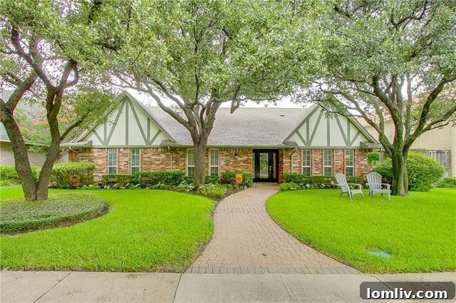 Charming Tudor home exterior with mature trees and a manicured lawn in Lake Highlands.